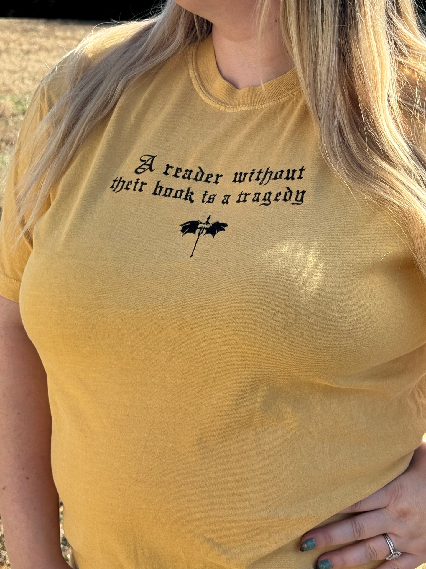 A Reader Without Their Book Is a Tragedy Tee